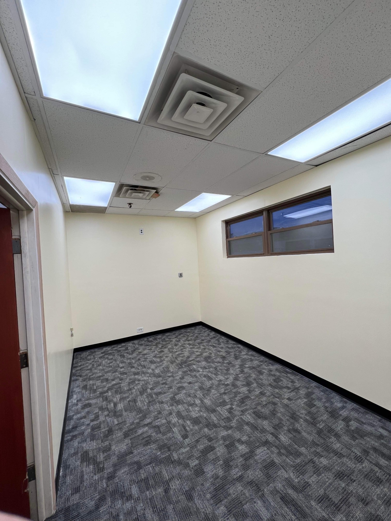 Finished commercial office with smooth painted drywall walls and clean baseboard by R&M Drywall